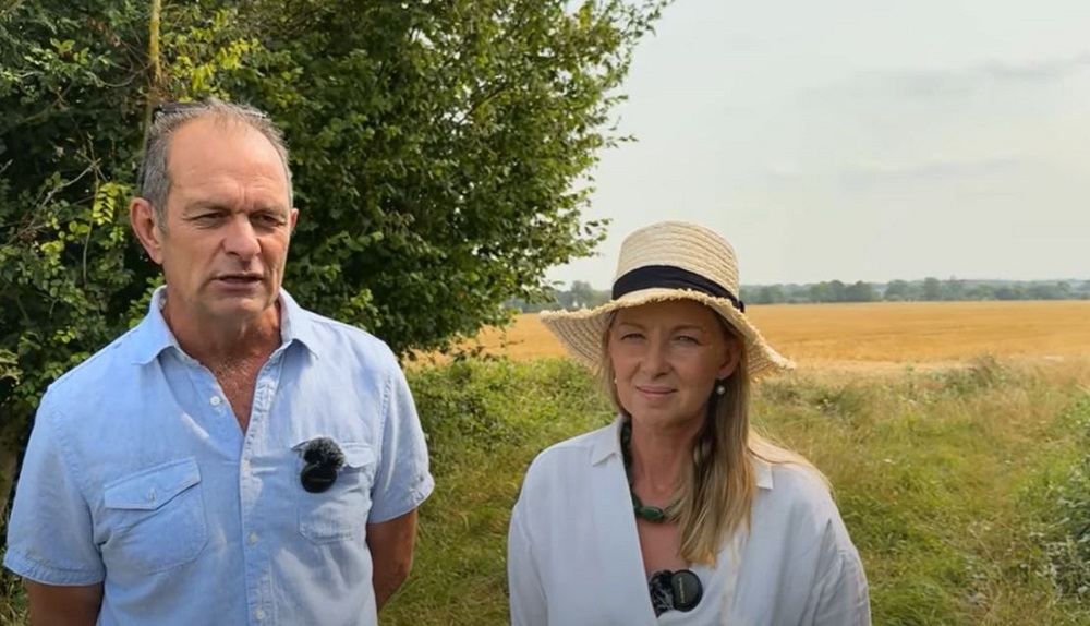 Two cover crop champions talking in a field 